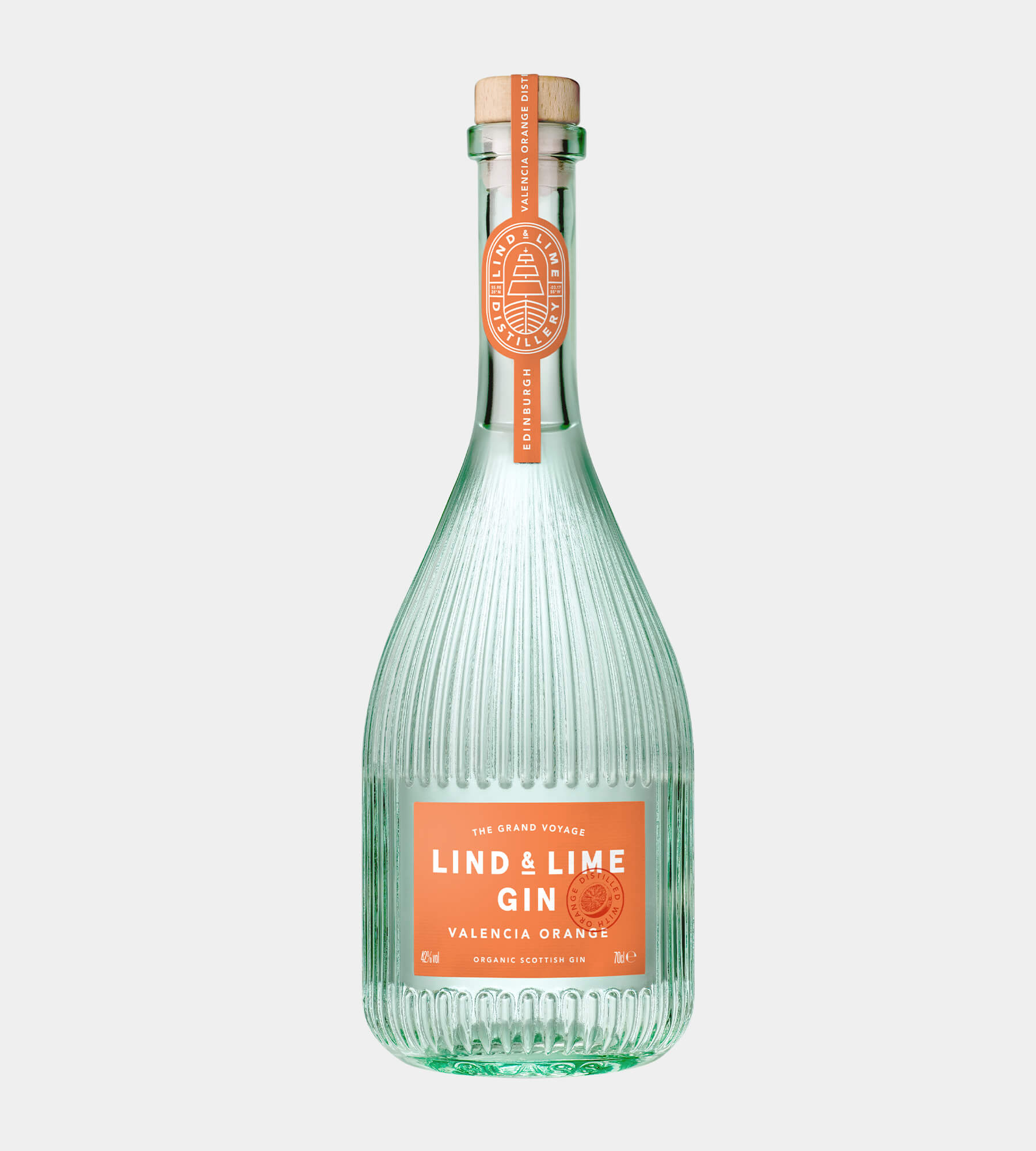A clear ribbed glass bottle of Lind & Lime Gin with a light green tint, featuring a coral orange label and a matching neck seal, set against a solid light gray background.